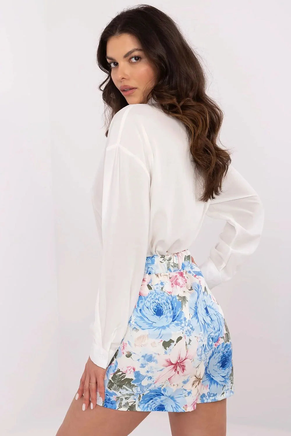 Tenue élégante pour femme chemisier blanc col boutonné jupe imprimée fleurs bleues roses vertes coupe ajustée style moderne confortable occasionnal