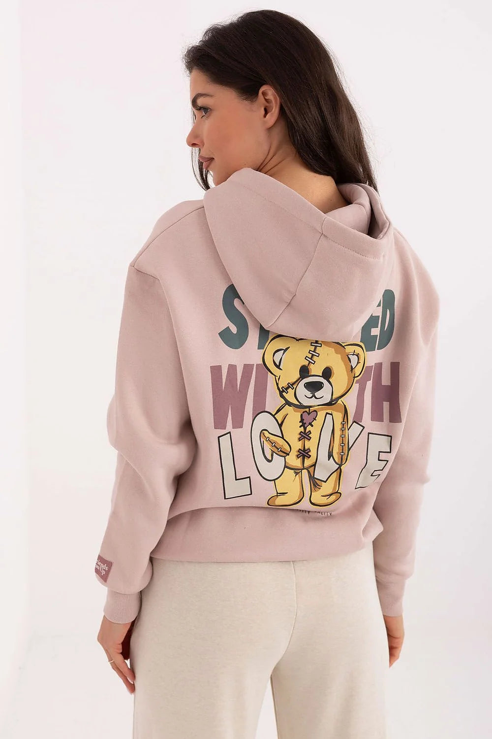 hoodie femme rose poudré molleton doux coupe loose courte poche kangourou poignets côtelés capuche réglable cordons blancs embouts verts contrastés