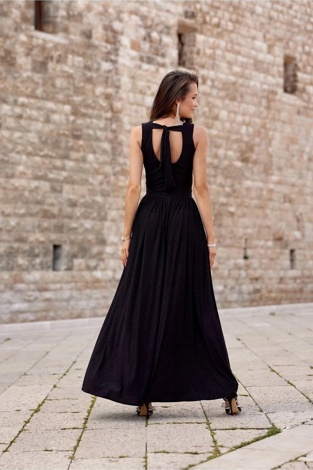 Robe de soirée longue sans manches V croisé fente haute robe noire scintillante épaules mises en valeur sandales talons femme