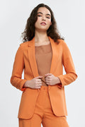 Tailleur élégant pour femme en orange vibrant, veste et pantalon, coupe classique, manches longues, épaules définies, occasion professionnelle