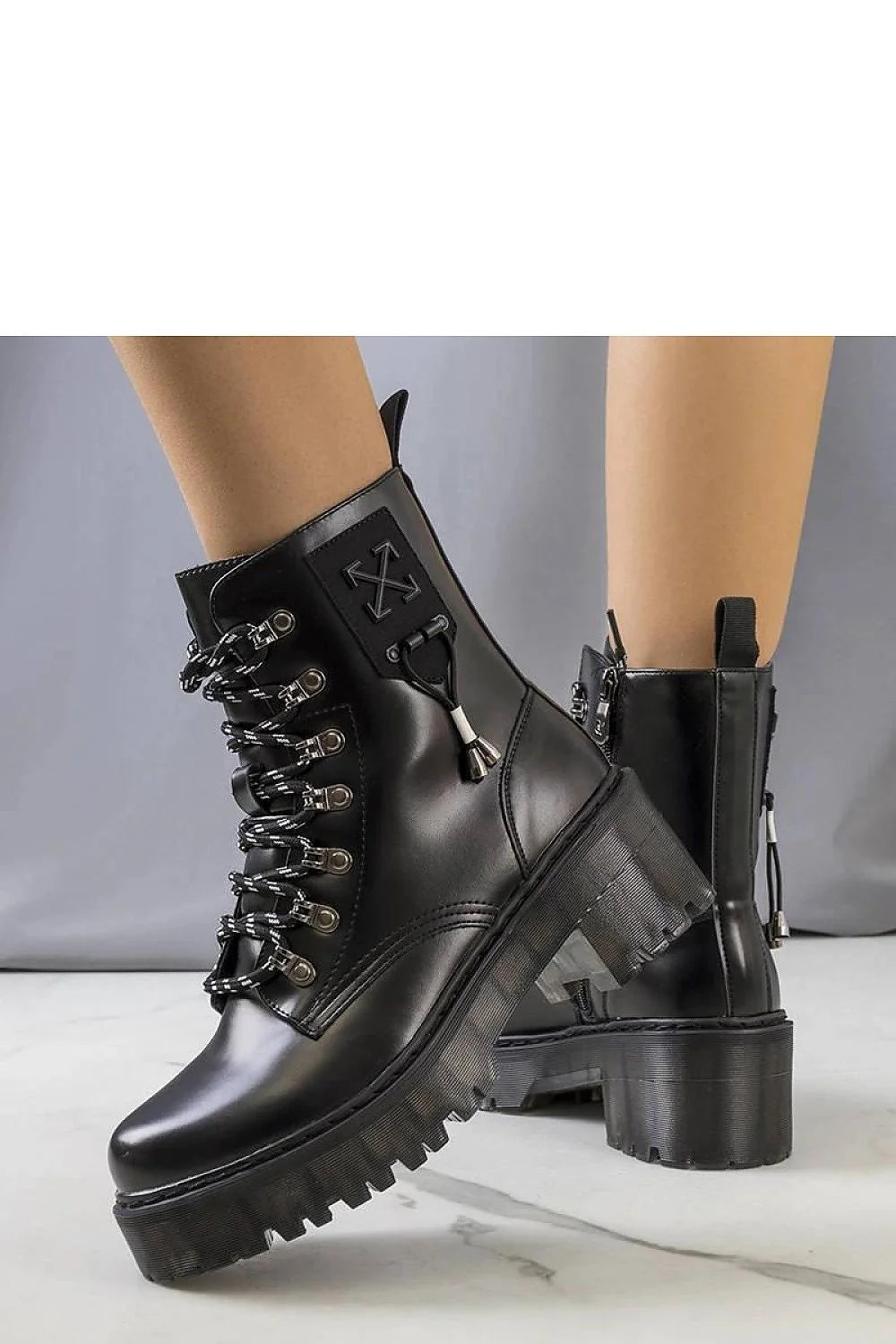 Bottes combat femme style audacieux cuir noir semelle épaisse lacets bicolores métalliques renfort cheville