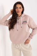 hoodie femme rose poudré molleton doux coupe loose courte poche kangourou poignets côtelés capuche réglable cordons blancs embouts verts contrastés