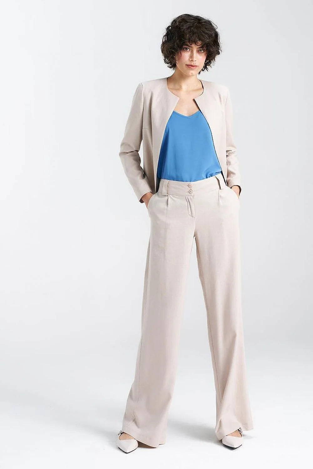 Pantalon femme élégant beige clair coupe large taille haute ceinture large poches latérales fermeture éclair boutons