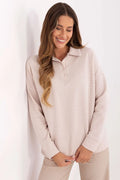 polo femme maille gaufrée beige rosé oversize épaules tombantes manches longues poignets côtelés ourlet droit douce légèrement extensible casual chic
