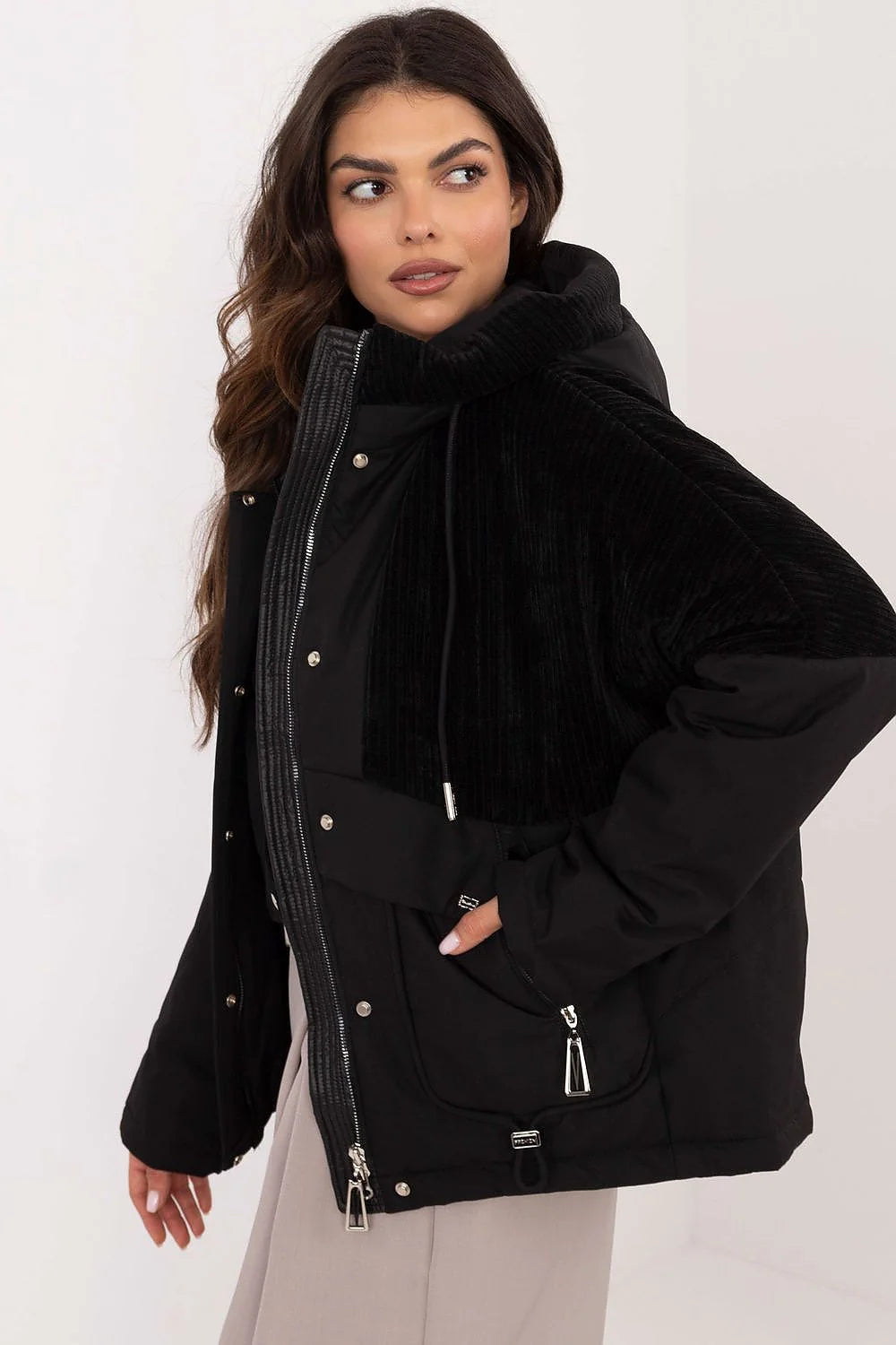 Veste urbaine moderne pour femme en polyester noir avec capuche fixe, poches zippées, finitions métalliques et coupe décontractée