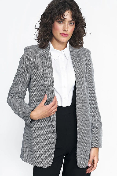 Blazer femme motifs chevrons noir et blanc coupe ajustée épaules structurées matières nobles élégance polyvalence femme