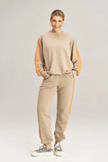 ensemble athlétique féminin casual oversize molleton beige sable bandes orange manches longues jogger ceinture élastique poches latérales confortable respirant polyvalent