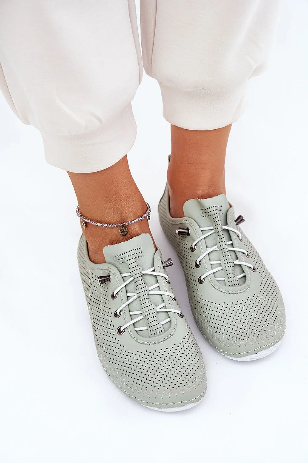 chaussures basses femme cuir perforé vert pâle sauge minimaliste contemporain respirante lacets blancs oeillets métalliques semelle blanche antidérapante