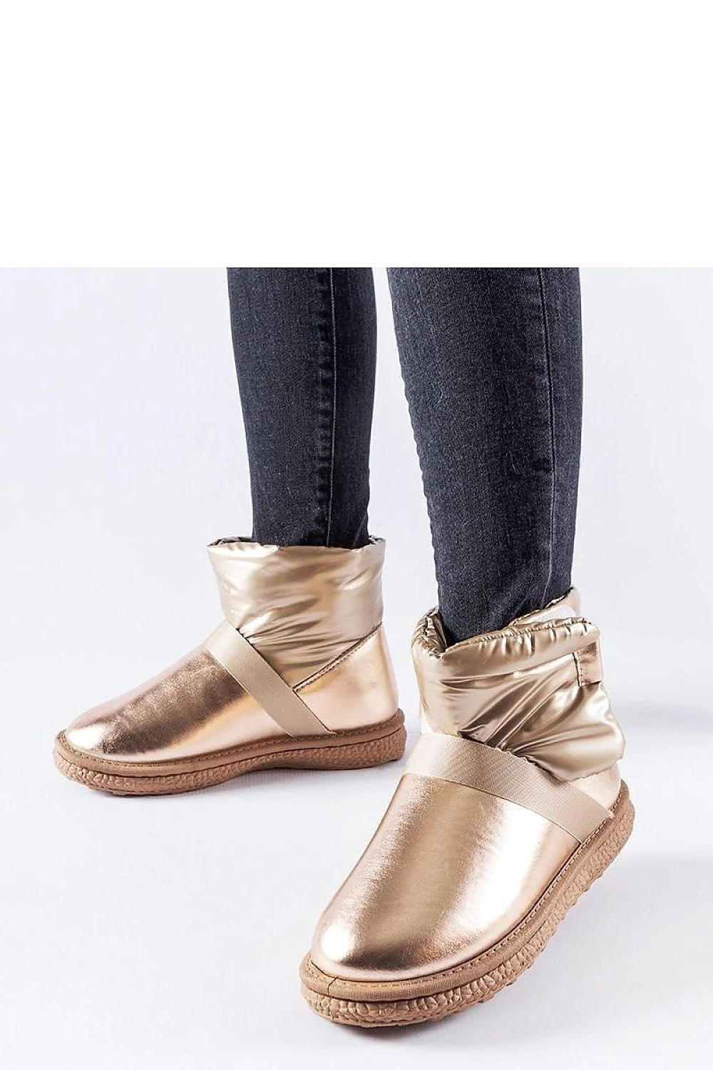 Bottines enneigées dorées métalliques moderne design compact silhouette profilée semelle caoutchouc élastique sangle femmes urban style hiver