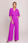 Combinaison féminine élégante couleur fuchsia vif polyester élasthanne coupe ample manches mi-longues pantalon large poches latérales occasion semi-formelle femme mode 2023