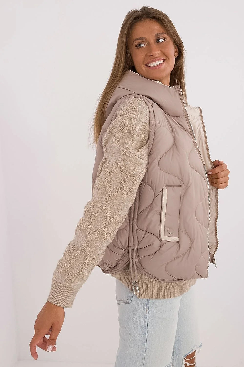Gilet sans manches pour femme en tissu matelassé beige doux, doublure claire, isolation synthétique légère, capuche ajustable, fermeture éclair métal, poches latérales, coupe droite, style décontracté, idéal pour les saisons intermédiaires