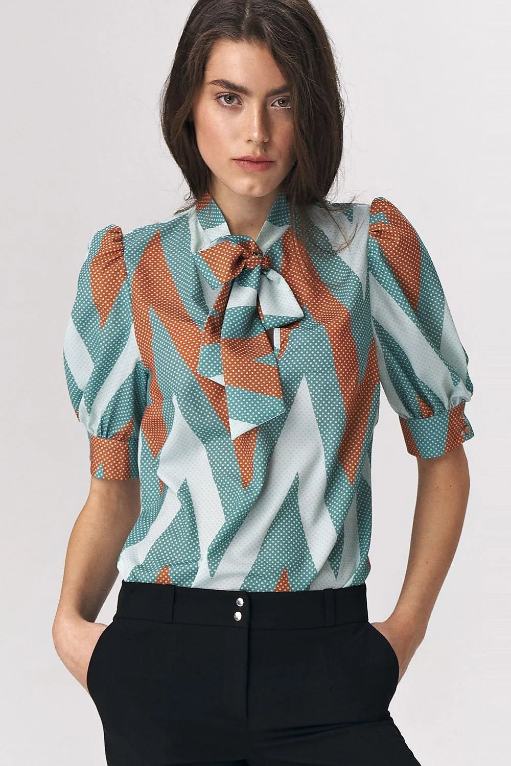 Chemisier audacieux pour femme en turquoise, orange et blanc, motif géométrique, manches bouffantes, col en nœud, polyester 98% élasthanne 2%