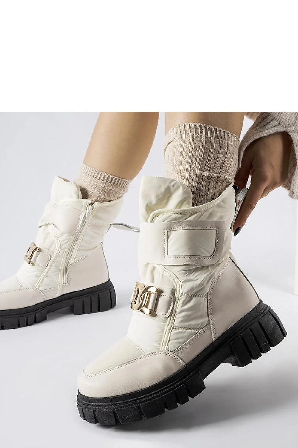 Bottes de neige Solea pour femmes style moderne élégant couleur beige cassé matériau synthétique détails dorés confort protection froid hiver